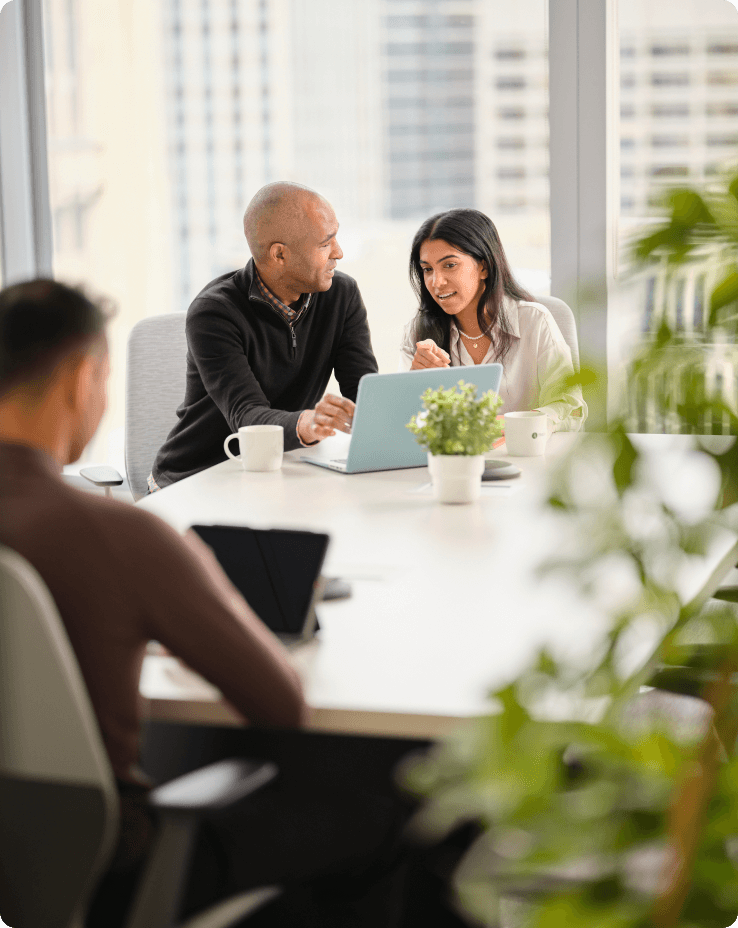 three people sitting in lobby working