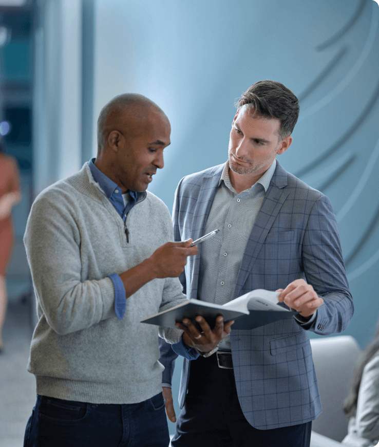 two men reviewing work