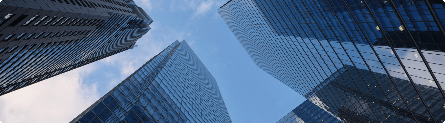 looking up at three high rise buildings