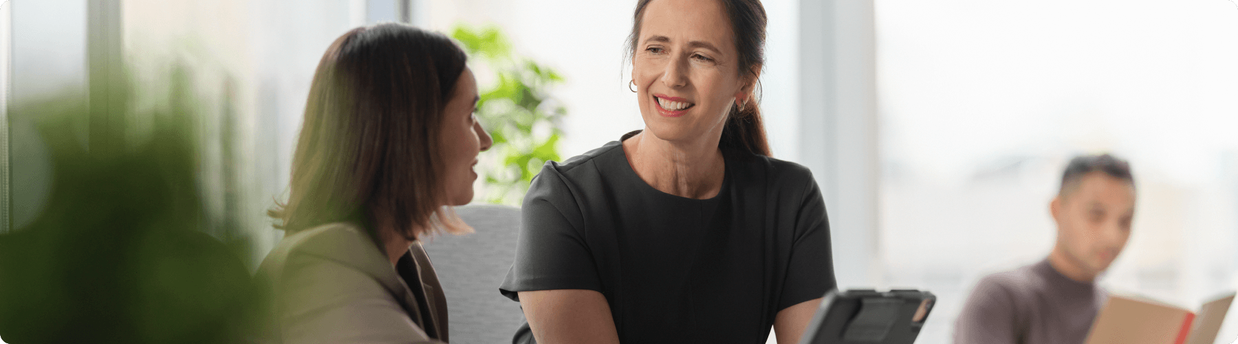 two colleagues meeting in front of laptop