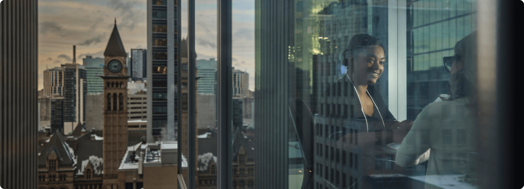 close up of two people in meeting from exterior glass window