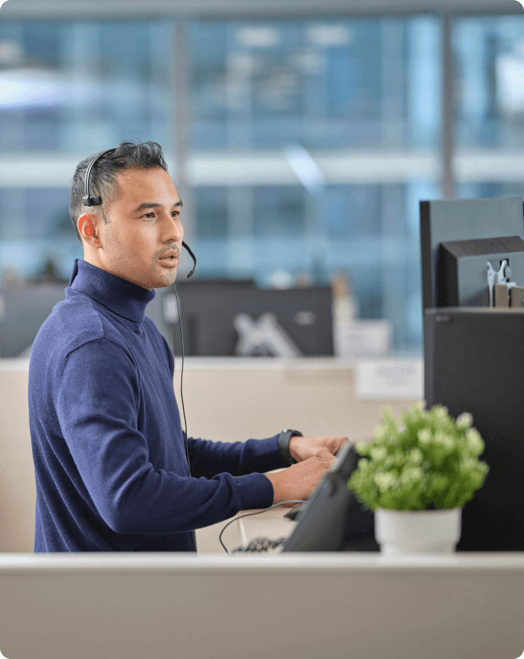 man with headset working on computer