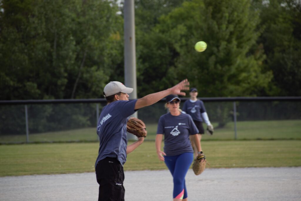 A player with his hand extended ready to catch a ball.